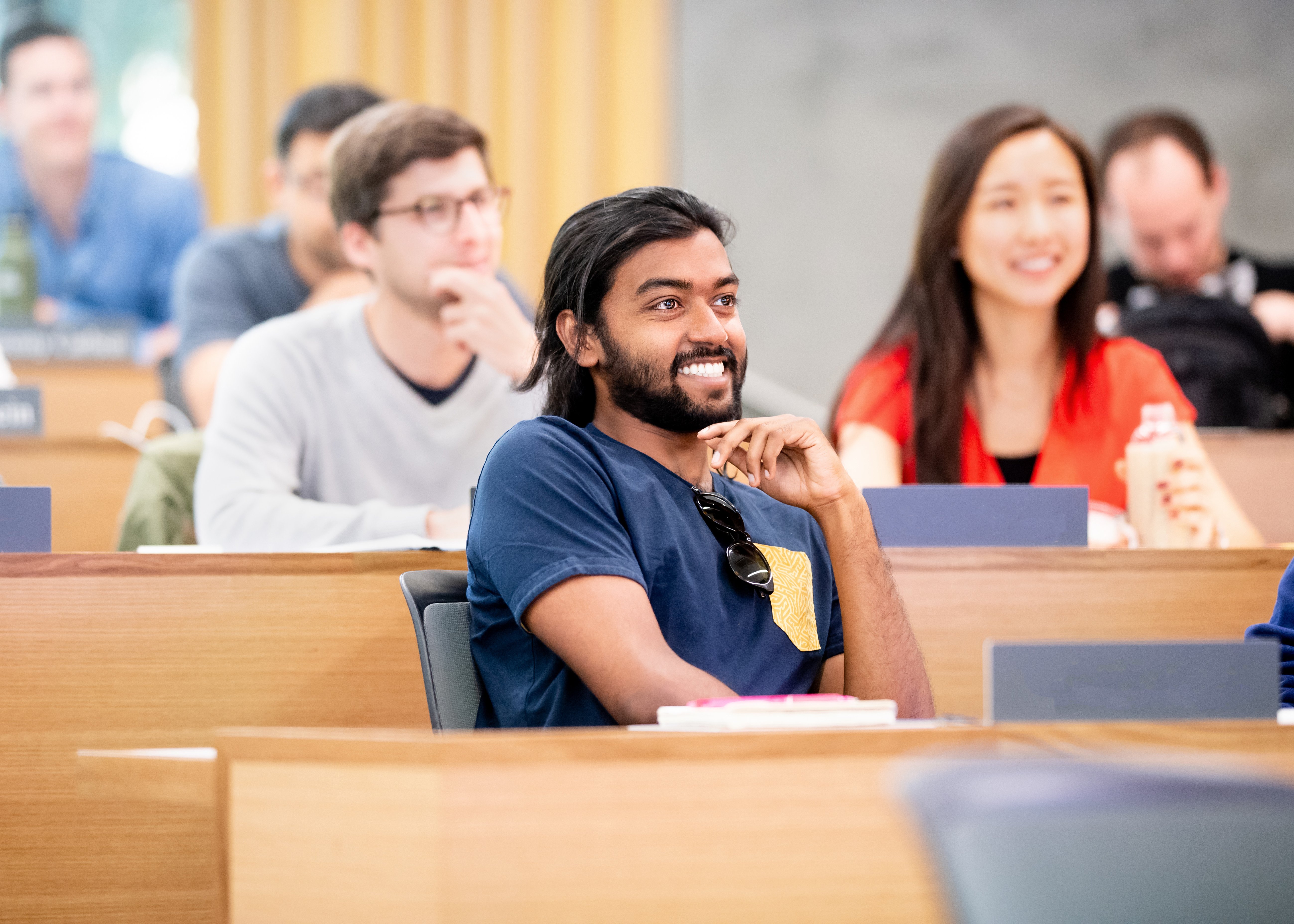 A male student smiling in class