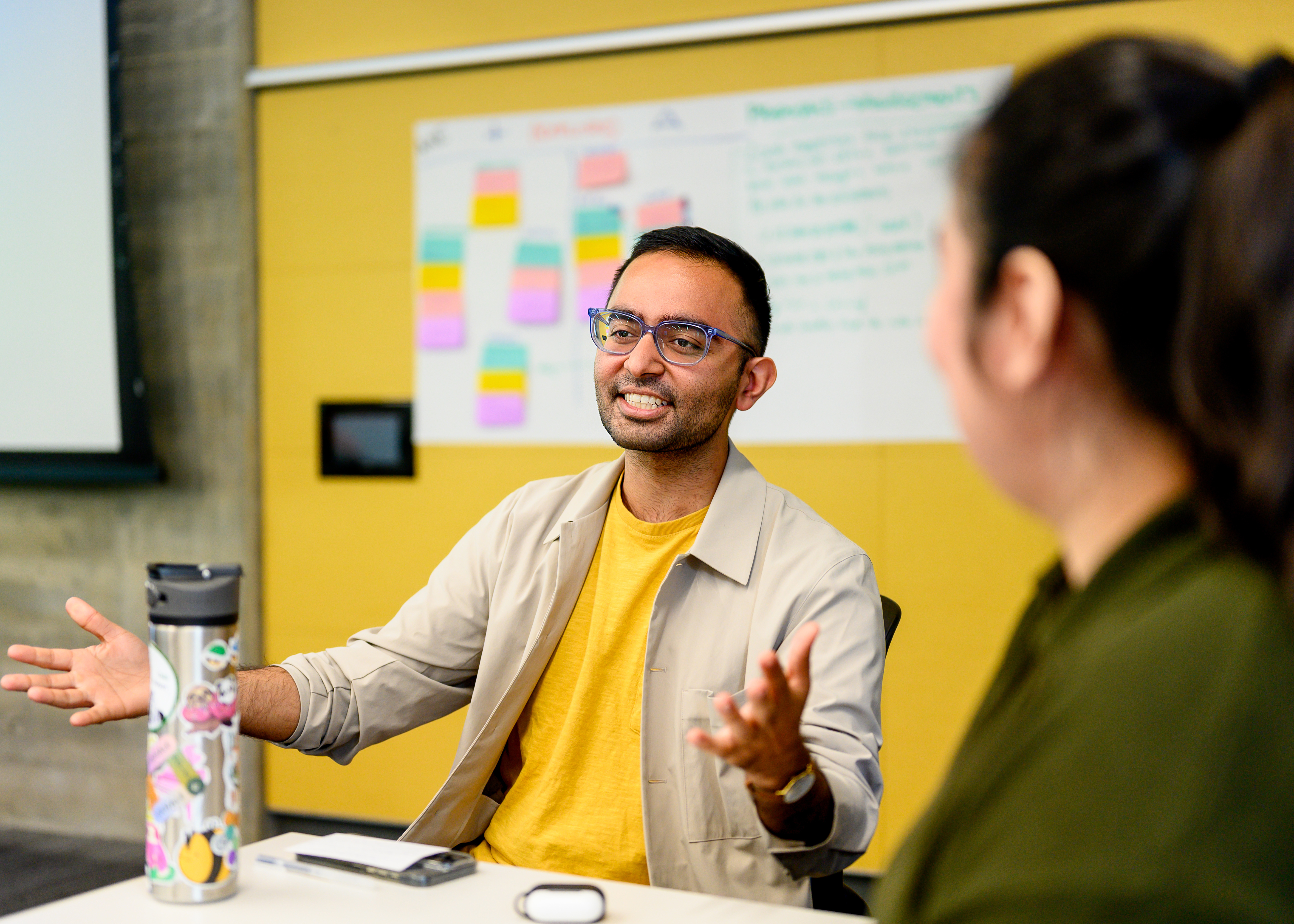 A male student gestures with his hands during a conversation