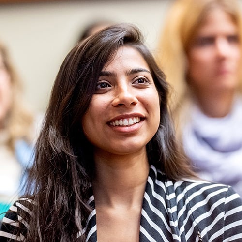 A female student smiling in class