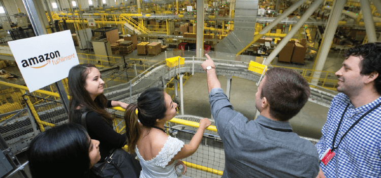 A group of students looking at an Amazon fulfillment center